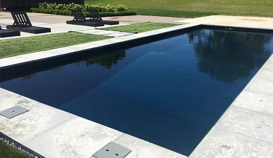 Leisure Pools Columbus Ohio The Grand fiberglass pool large rectangular shape with an ebony blue color.